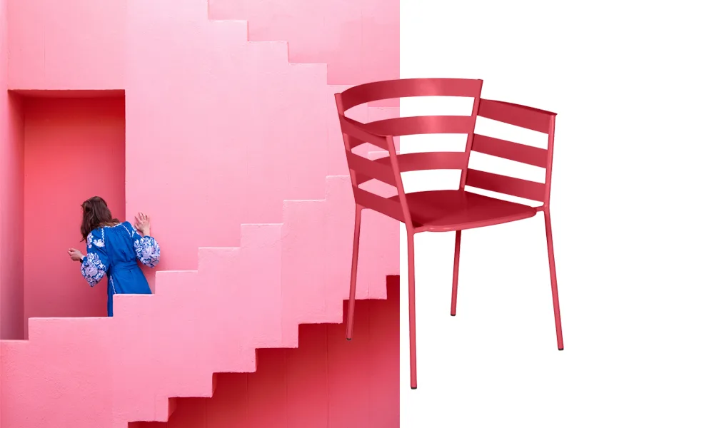 Fermob's new 2027 color Rosalie: a pink metal chair beside a pink stairway